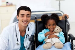 Young child being cared for by a doctor in a hospital.jpeg